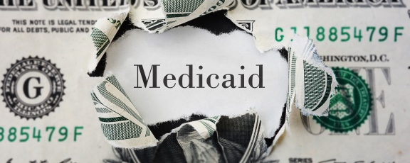 photo of a dollar with word Medicaid inside