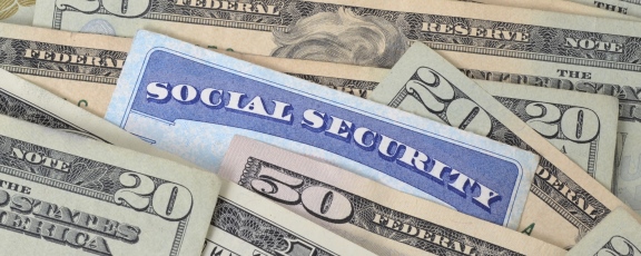 Photo of Social Security Card on table with dollar bills