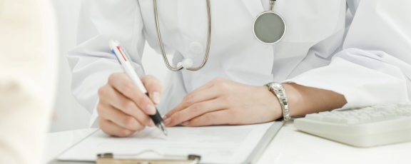 Photo of doctor's hands taking notes