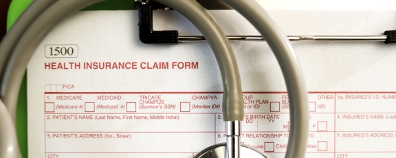 Photo of medical claim form with stethoscope on top of it